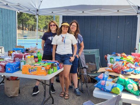 Mrs. Homan, Ms. Lacoste, and Ms. Garcia surrounded by the donations that were brought by each grade for the Humanities Picnic.