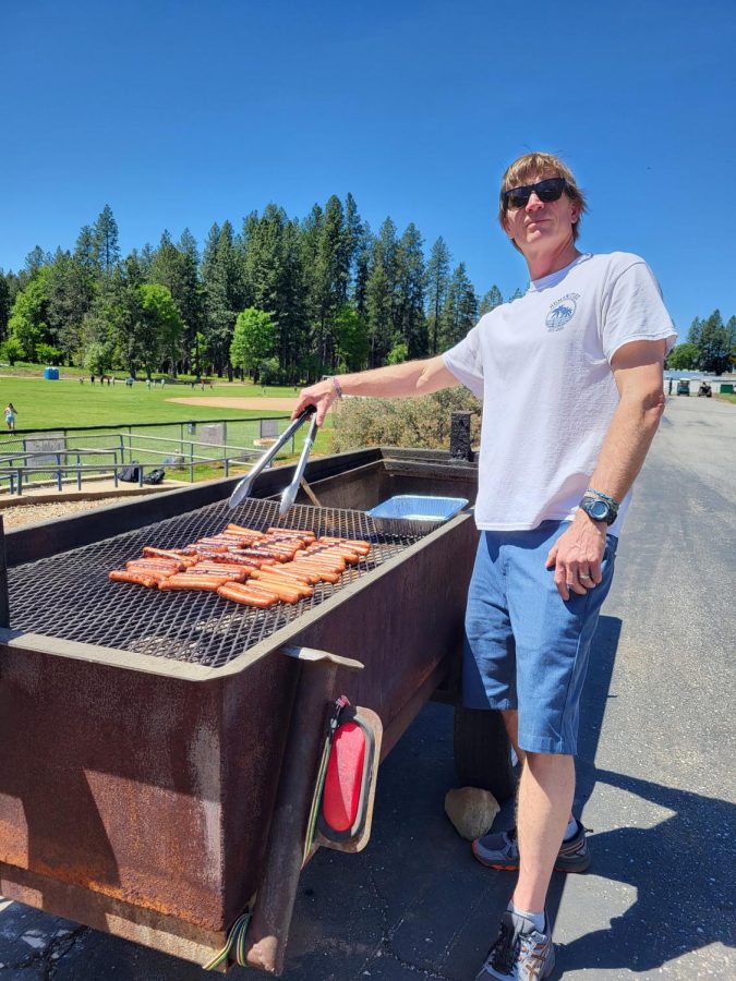 Mr. Homan grilling the hot dogs that were served for lunch during the picnic.