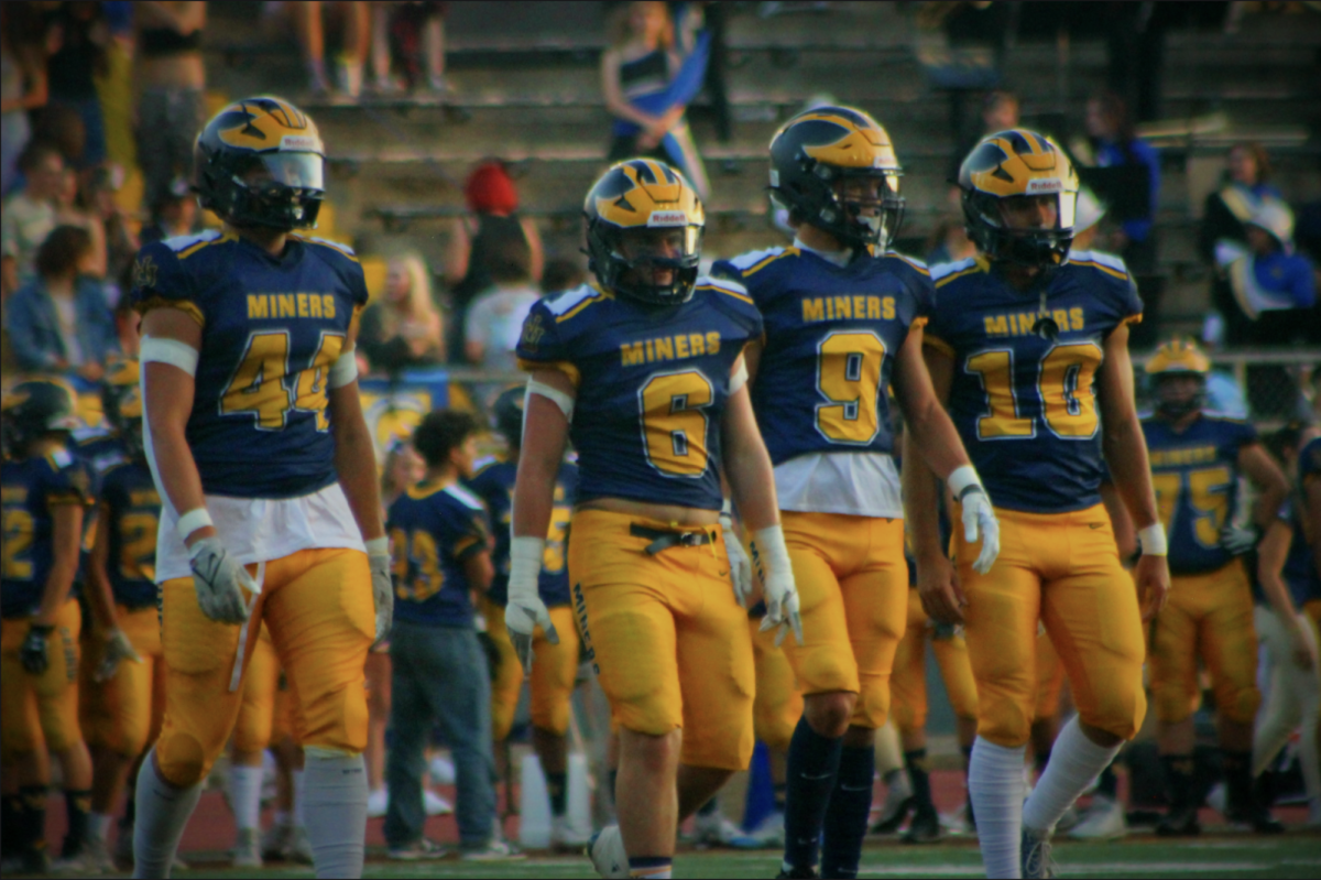 Miners captains Bodey Eelkema (12), Jake Barefield (11), Carter Van Matre (11),  and Dustin Philpott walk onto the field before starting their game.